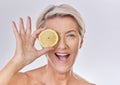 Skincare, wellness and face of mature woman with wrinkles holding lemon with nutrition, vitamins and health. Portrait of