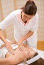 Skincare - woman cleavage massage at salon