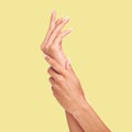 Skincare, yellow background and hands of woman in studio for wellness, cosmetics and manicure treatment. Spa aesthetic