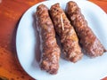 Skinless meat roll sausage or mici traditional balkan romanian ottoman cuisine delicacy served with mustard