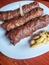 Skinless meat roll sausage or mici traditional balkan romanian ottoman cuisine delicacy served with mustard