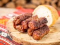 Skinless meat roll sausage or mici traditional balkan romanian ottoman cuisine delicacy served on a wooden plate in a rustic decor Royalty Free Stock Photo