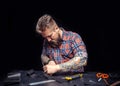 Leather man processing a leather workpiece at the workplace Royalty Free Stock Photo
