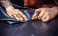 Artisan produce a leatherwork in a workshop