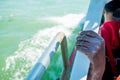 Close up of thin and skinny african migrant man hand on boat while crossing mediterranean sea to europe on sunny day