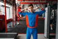 Skinny man in sportswear shows his muscles, gym Royalty Free Stock Photo