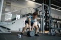 Skinny nerd wimp trying to lift heavy dumbbells at gym Royalty Free Stock Photo