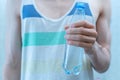 skinny sportsman with a plastic bottle with pure water while workout