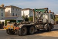 A skip carrier lorry parked on the side of the road