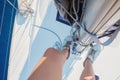 Skipper of a sailing ship. Climbing up the mast, driving a yacht, yachting. Royalty Free Stock Photo