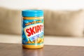 Skippy creamy peanut butter in plastic bottle in kitchen