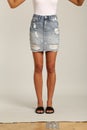 A Skirt in Blues Denim, Shorts feature a high waist, with a longer rise, relaxed leg with frayed hems, and classic five-pocket