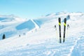 Skis and poles pinned into the snow. Ski slope in the background Royalty Free Stock Photo