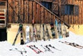 Skis and snowboards on the snow against alpine chalet Royalty Free Stock Photo