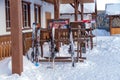 Skis stand on supports near the main building of the resort