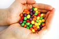 Skittles multicolored fruit candies in woman hands