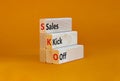 SKO sails kick off symbol. Concept words SKO sails kick off on wooden blocks. Beautiful orange table, orange background, copy