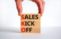 SKO sails kick off symbol. Concept words SKO sails kick off on wooden blocks. Beautiful white background, businessman hand, copy