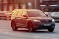 Skoda Kodiaq in the motion on the highway. SUV car drive on asphalt city road while sunset. Unacceptable speeding in the city