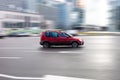 Skoda Roomster compact popular car on the city highway in motion, side view. Red family mpv driving on the street Royalty Free Stock Photo