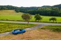 Skoda Scala car standing on the countryside road with amazing view on the valley and lush trees