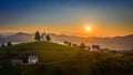 Skofja Loka, Slovenia - Aerial panoramic view of amazing golden sunrise at the beautiful hilltop church of Sveti Tomaz Royalty Free Stock Photo