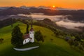 Skofja Loka, Slovenia - Aerial panoramic view of the beautiful hilltop church of Sveti Tomaz Saint Thomas with golden sunrise Royalty Free Stock Photo