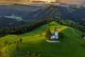 Skofja Loka, Slovenia - Aerial panoramic view of the beautiful hilltop church of Sveti Tomaz Saint Thomas with golden sunset