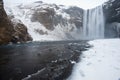 Skogafoss waterfall covered in ice and snow