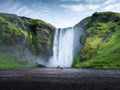 Skogafoss waterfall, Iceland. Mountain valley and clear sky. Natural landscape in summer season. Icelandic nature. Group of a peop Royalty Free Stock Photo