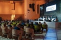 Audience listening to businesspeople during seminar