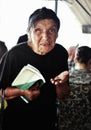 SKOPJE, MACEDONIA - JUNE 20,2013:Older woman with eye problems holding healt card in his hand begging for money in a