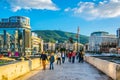 SKOPJE, MACEDONIA, MAY 14, 2016: People are passing over the ancient stone bridge in the macedonian capital skopje Royalty Free Stock Photo