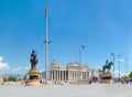 Undefined tourists visit Skopje center, square Macedonia. View of Stone Bridge approach, Archeological museum and two worrior stat Royalty Free Stock Photo