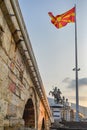Skopje,Stone Bridge, with Macedonian flag and statue of warrior on horse