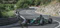 Skradin Croatia, June 2020 Green and black formula racecar seen from distance entering a corner going uphill during a race