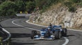 Skradin Croatia, June 2020 Green and black formula racecar seen from distance entering a corner going uphill during a race