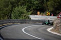Skradin Croatia, June 2020 Green and black formula racecar seen from distance going uphill during a race championship