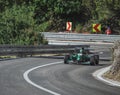 Skradin Croatia, June 2020 Green and black formula racecar seen from distance going uphill during a race championship