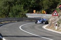 Skradin Croatia, June 2020 Green and black formula racecar seen from distance going uphill during a race championship