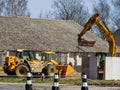 Skrunda, Latvia - April 20, 2022: JCB 550-80 Telehandler and JCB JS160 Tracked Excavator at the railway tracks