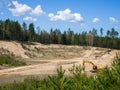 Skrunda, Latvia - May 3, 2022: Yellow excavator JCB JS 220 LC is located in a quarry