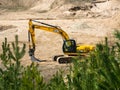 Skrunda, Latvia - May 3, 2022: Yellow excavator JCB JS 220 LC is located in a quarry