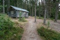 Skuleskogen, Sweden - 08.22.2021: Wooden cabin in the forest of Skuleskogen national park in Sweden with pile of birch Royalty Free Stock Photo