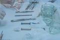 Neurosurgical instruments, including a titanium plate for implantation in the skull, are on the sterile operating table of a nurse