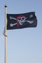 A pirate flag flying on a sunny day