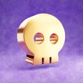 Skull icon. Gold glossy Skull symbol isolated on violet velvet background.