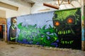 Skull monster graffiti in an abandoned factory building.