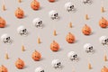 Skulls, pumpkins and witch broomsticks pattern on a grey background. Royalty Free Stock Photo