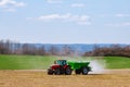 Skutc, Czech Republic - March 23 2020: Tractor spreading fertilizer on grass field. Agricultural work